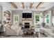 Cozy living room features wood beams, a fireplace, and an abundance of natural light at 4842 Durneigh Dr, Kannapolis, NC 28081