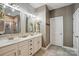 Elegant main bathroom featuring double sinks, granite countertops, white cabinetry, and modern fixtures at 4842 Durneigh Dr, Kannapolis, NC 28081