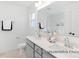 Bathroom showcasing double sink vanity, large mirror, neutral gray walls and flooring at 499 Switch St # 128, York, SC 29745