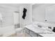 Bathroom featuring a single sink vanity, mirror, tub and a shower combo at 499 Switch St # 128, York, SC 29745