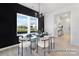 Elegant dining area with modern chairs, a glass table, and a black accent wall at 499 Switch St # 128, York, SC 29745