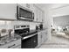 Close up of a stainless oven and microwave with gray cabinets and subway tile back splash at 499 Switch St # 128, York, SC 29745