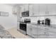 Modern kitchen with gray cabinets, stainless steel appliances, and stone countertops at 499 Switch St # 128, York, SC 29745