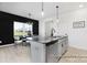 Contemporary kitchen features a large island with seating, modern lighting, and stylish finishes at 499 Switch St # 128, York, SC 29745