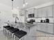 Modern kitchen with gray cabinets, stainless steel appliances, and a marble-topped island with seating at 499 Switch St # 128, York, SC 29745