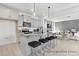 Open concept kitchen with island, gray cabinets, stainless appliances and view into living area at 499 Switch St # 128, York, SC 29745