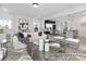 Open-concept living room featuring a comfortable sofa, decorative coffee table, and seamless access to the dining area at 499 Switch St # 128, York, SC 29745