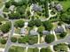 An aerial view of a quiet neighborhood, featuring lush greenery, mature trees, and well-maintained homes at 503 New Castle Ne Ct, Concord, NC 28025