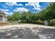 Expansive backyard with mature trees and a large concrete pad, perfect for outdoor activities at 503 New Castle Ne Ct, Concord, NC 28025