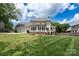 Spacious backyard features lush lawn and a house with a patio at 503 New Castle Ne Ct, Concord, NC 28025