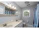 Bright bathroom with double vanity, large mirror, and shower at 503 New Castle Ne Ct, Concord, NC 28025