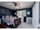 Stylish blue bedroom with a decorative elephant wall hanging, and natural light at 503 New Castle Ne Ct, Concord, NC 28025