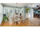 Charming dining area features hardwood floors, a round table, and plenty of natural light from surrounding windows at 503 New Castle Ne Ct, Concord, NC 28025