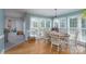 Comfortable dining area with hardwood floors, natural light, and view into play area at 503 New Castle Ne Ct, Concord, NC 28025