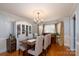 Refined dining room featuring hardwood floors, a classic chandelier, and ample seating for gatherings at 503 New Castle Ne Ct, Concord, NC 28025