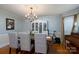 Elegant dining room with hardwood floors, chandelier, large dining table, and vintage wallpaper at 503 New Castle Ne Ct, Concord, NC 28025