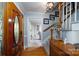 Welcoming foyer featuring hardwood floors, a wooden staircase, and view into the sunlit living room at 503 New Castle Ne Ct, Concord, NC 28025