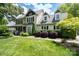A charming two-story home with dormer windows, black shutters, manicured landscaping, and a well-maintained lawn at 503 New Castle Ne Ct, Concord, NC 28025