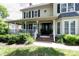 Inviting front porch with white railings, comfortable seating, and a glimpse of the home's entrance at 503 New Castle Ne Ct, Concord, NC 28025