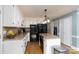 Well-appointed kitchen with white cabinets, granite countertops, black appliances, and ample storage space at 503 New Castle Ne Ct, Concord, NC 28025