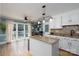 Bright kitchen with granite countertops, an island, and natural light flowing in from large windows at 503 New Castle Ne Ct, Concord, NC 28025