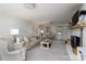 Bright and airy living room featuring a cozy fireplace, neutral decor, and ample natural light at 503 New Castle Ne Ct, Concord, NC 28025