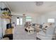 Spacious living room with a brick fireplace, neutral carpet, and comfortable seating arrangement at 503 New Castle Ne Ct, Concord, NC 28025