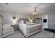 Comfortable main bedroom includes a decorative chandelier, neutral tones, and an ensuite bathroom entrance at 503 New Castle Ne Ct, Concord, NC 28025