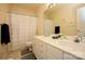 Bright bathroom with double sink vanity, large mirror, and tiled shower with decorative curtain at 6009 Swanston Dr, Charlotte, NC 28269