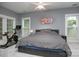 Spacious bedroom with natural light, a ceiling fan, a stationary bike, and comfortable gray carpet at 6009 Swanston Dr, Charlotte, NC 28269