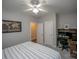 Neutral bedroom with ceiling fan, study area with computer, and door leading to another room at 6009 Swanston Dr, Charlotte, NC 28269