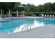 Sparkling community pool with ample lounge chairs and a pergola, perfect for summer relaxation at 6009 Swanston Dr, Charlotte, NC 28269