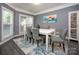 This dining room features a modern white table with seating for four on a beautiful patterned rug at 6009 Swanston Dr, Charlotte, NC 28269