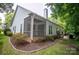 Charming home exterior with a screened porch and beautifully landscaped yard at 6009 Swanston Dr, Charlotte, NC 28269