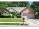 Charming brick home with a well-manicured lawn, two-car garage, and basketball hoop in a residential neighborhood at 6009 Swanston Dr, Charlotte, NC 28269