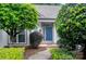 Charming front entrance with a blue door, mature landscaping, and brick walkway at 6009 Swanston Dr, Charlotte, NC 28269