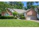 Charming brick home features a well-manicured lawn and established landscaping at 6009 Swanston Dr, Charlotte, NC 28269