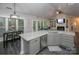 Open kitchen and living area showcases an island, granite countertops, and an eat-in kitchen area at 6009 Swanston Dr, Charlotte, NC 28269