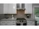 Modern kitchen features gray subway tile, sleek white cabinets, and stainless appliances at 6009 Swanston Dr, Charlotte, NC 28269