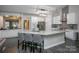 Open concept kitchen with a large island, modern stainless appliances and gray accent tile at 6009 Swanston Dr, Charlotte, NC 28269