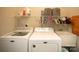 Functional laundry room with washer, dryer, storage shelves, and sink at 6009 Swanston Dr, Charlotte, NC 28269