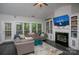 Comfortable living room boasts a fireplace, built-in shelving and large windows at 6009 Swanston Dr, Charlotte, NC 28269