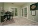 Study with neutral carpet, a window view, and glass doors to an outside balcony at 6009 Swanston Dr, Charlotte, NC 28269