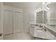 Bright bathroom featuring dual sinks with granite countertops, tile floors, and neutral paint at 6016 Gray Gate Ln # C, Charlotte, NC 28210