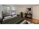 A cozy bedroom features a window view, a decorative console table, and a plush, comfortable bed at 6016 Gray Gate Ln # C, Charlotte, NC 28210