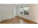 Bedroom featuring hardwood floors, a double door closet, and ample natural light at 6016 Gray Gate Ln # C, Charlotte, NC 28210