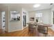 Bright dining room with wood floors and view to kitchen with white cabinets and stainless appliances at 6016 Gray Gate Ln # C, Charlotte, NC 28210