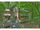 Charming home exterior with a wooden walkway and lush foliage and a view of the nearby pool at 6016 Gray Gate Ln # C, Charlotte, NC 28210