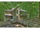 Inviting exterior of a multi-story home featuring a beautiful wooden walkway and lush greenery at 6016 Gray Gate Ln # C, Charlotte, NC 28210