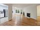 Bright living room with hardwood floors, a fireplace, and access to the outdoors through a glass door at 6016 Gray Gate Ln # C, Charlotte, NC 28210